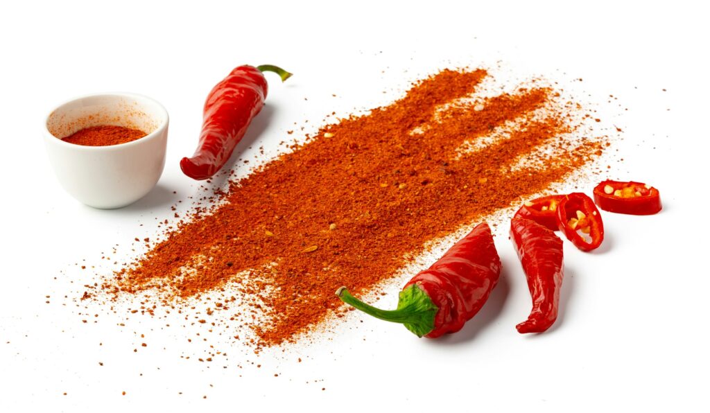 Pile of red paprika powder isolated on white background