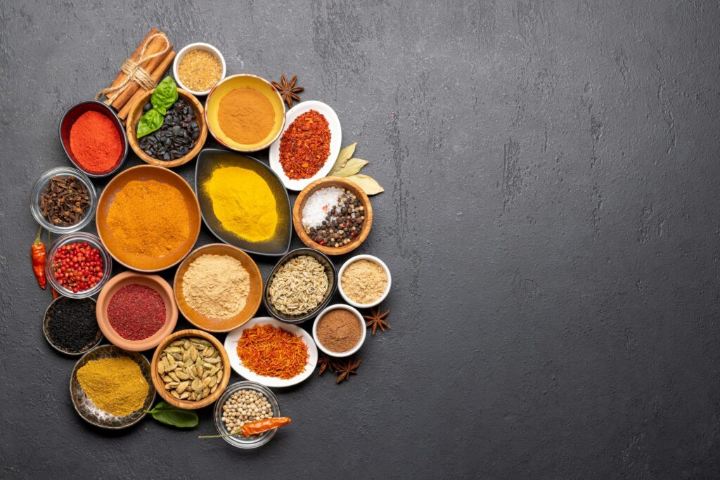 Various spices in bowls on stone table